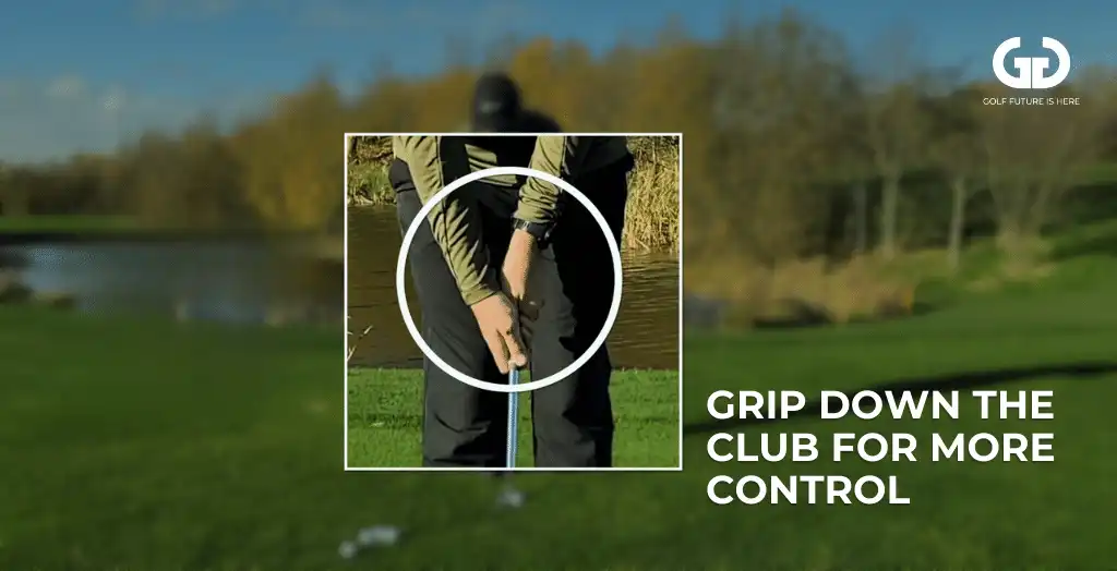 Golfer demonstrating how to grip the club from the bottom while chipping