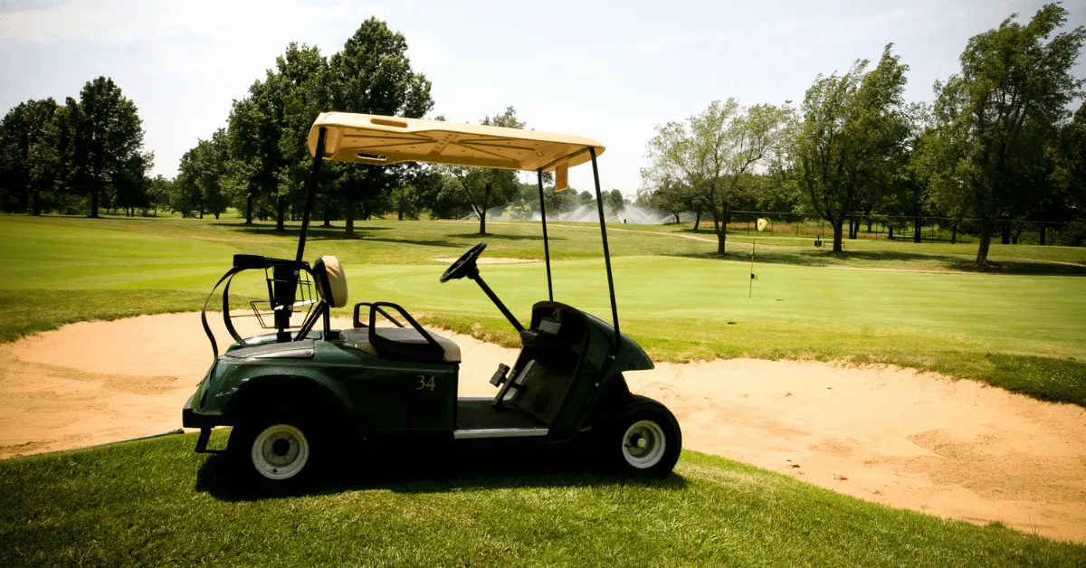 Side view of a green golf cart on a golf course