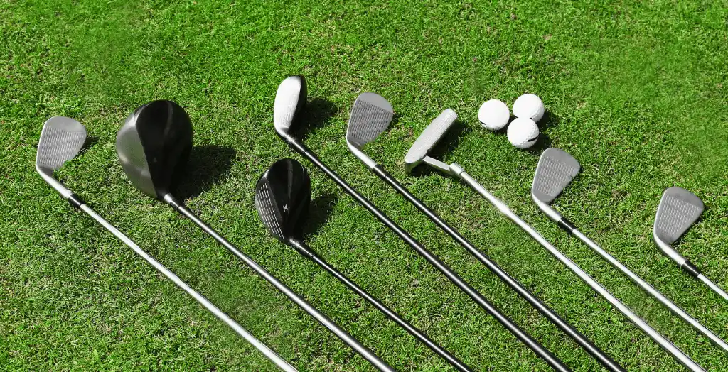 Different types of golf clubs kept on a golf course